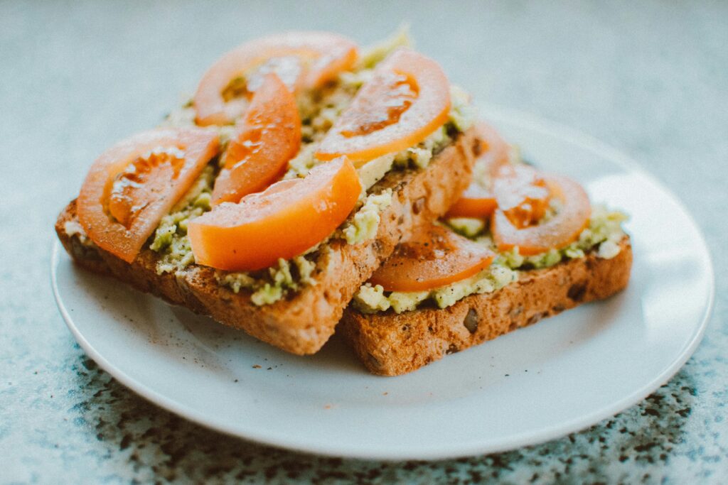 Delicious homemade sandwich with tomato, avocado on wholegrain bread, perfect for a healthy meal.